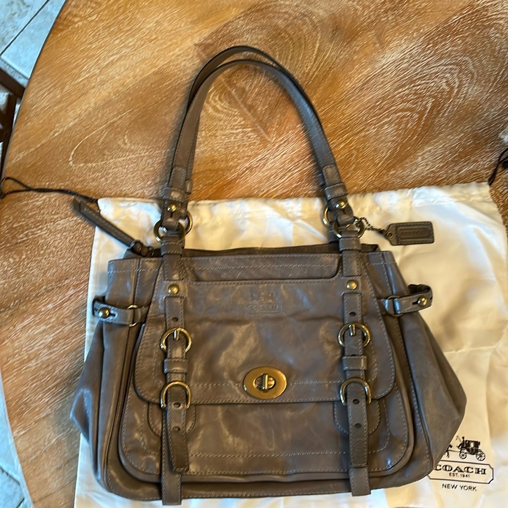 Coach leather shoulder bag with iconic striped fabric interior